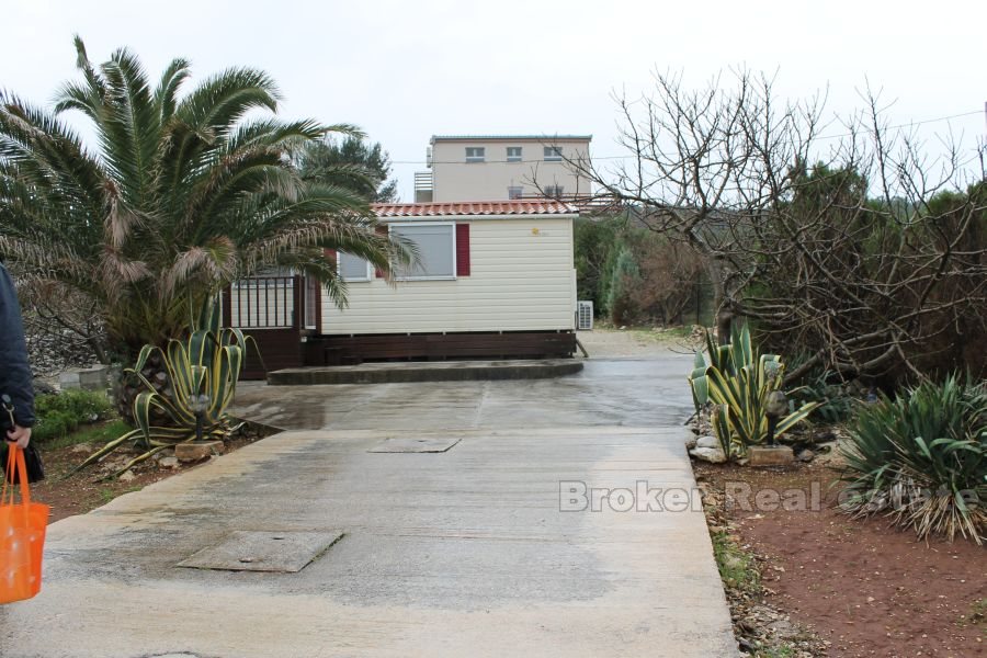 Building land with prefabricated house, for sale